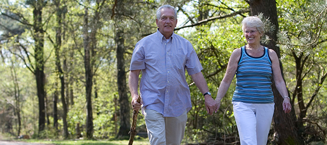 Senior Couple Relaxing In Autumn Landscape